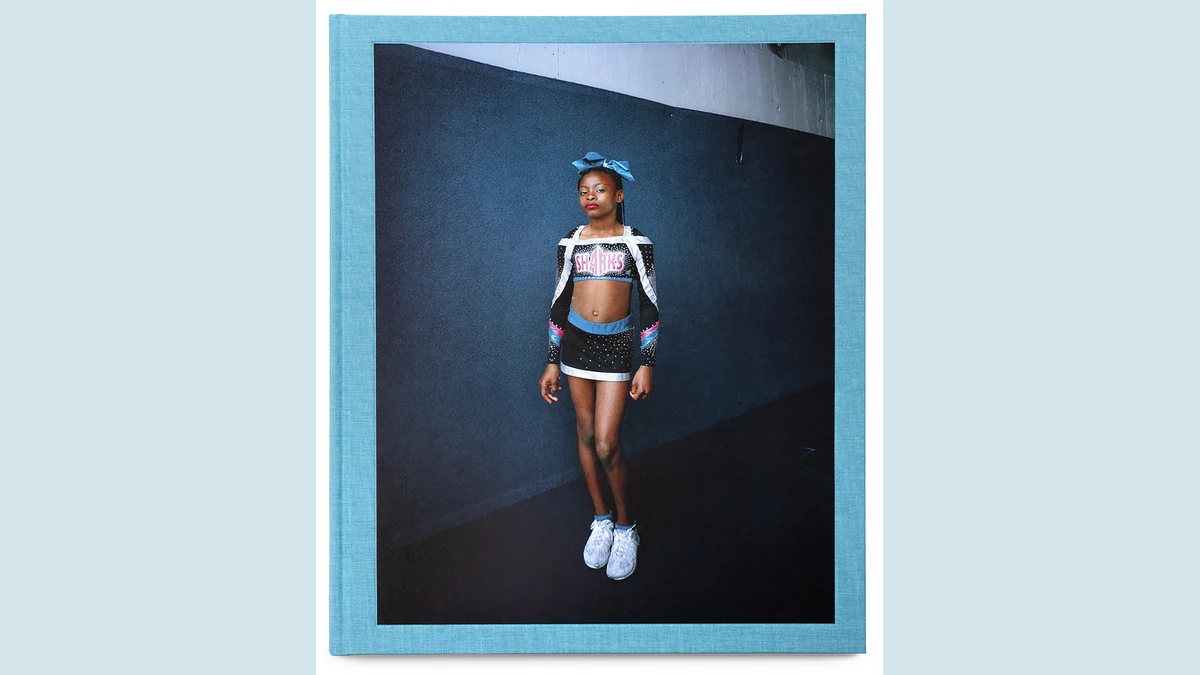Portrait of Jazmine in cheerleading attire on the cover of Eva Verbeeck’s America’s Girls book