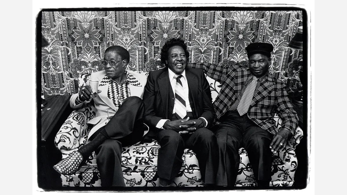 Lightnin’ Hopkins, Clifton Chenier and Honeyboy Edwards seated together on a floral sofa in New York, photographed by Harvey Wang in 1979.