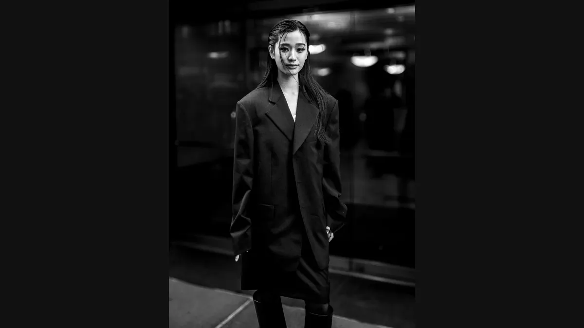 Phoebe Locke’s black-and-white photograph of a model in a dark coat outside the Calvin Klein show