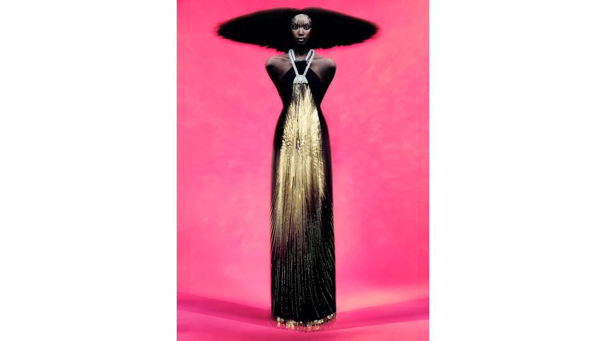 Rafael Pavarotti’s portrait of Anok Yai places a dark dress and wide hair silhouette against vivid pink, with bright strands running down the center