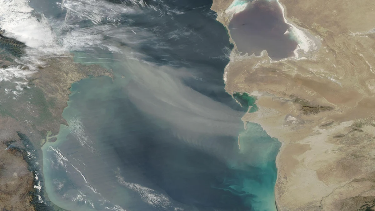 NASA Aqua MODIS view of pale dust spreading west across the dark Caspian Sea on September 24, 2026