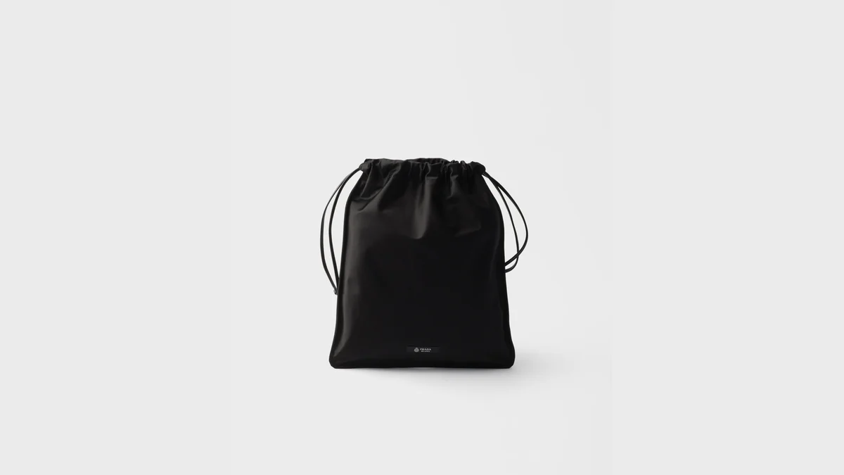 Official Prada photograph of a black Wish silk duchesse pouch with drawstring closure on a light background.