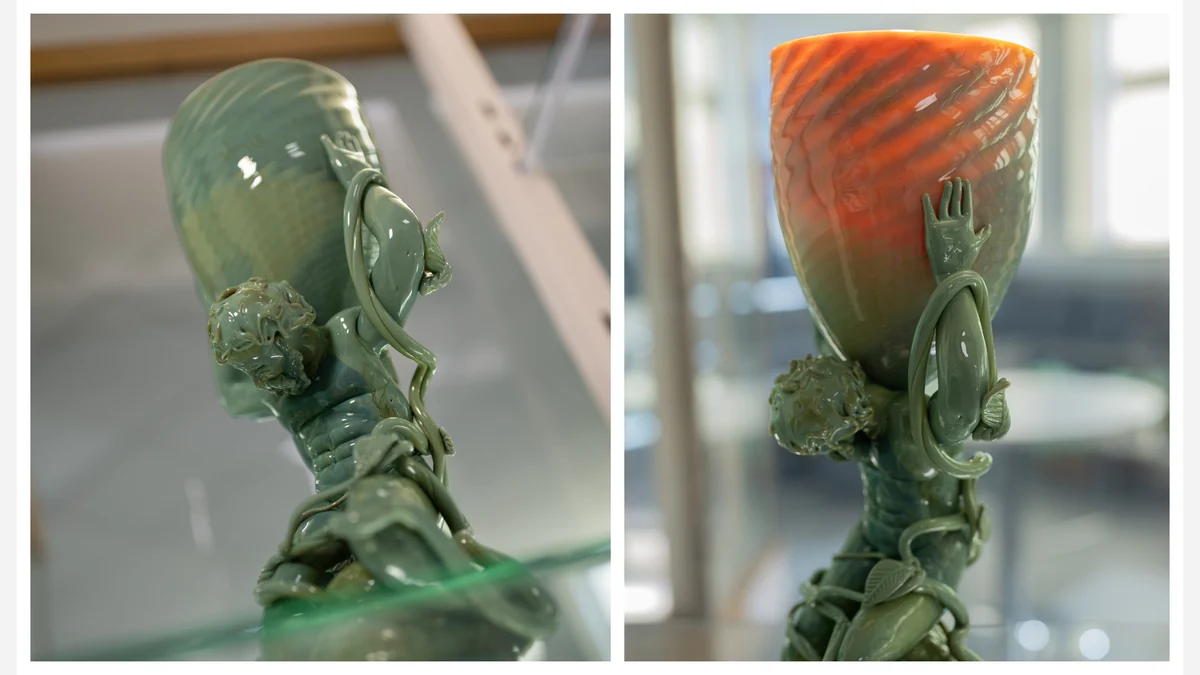 Source-published side-by-side photographs of Elliot Walker’s sculpture, with its glass cup appearing green in reflected light and red in transmitted light.
