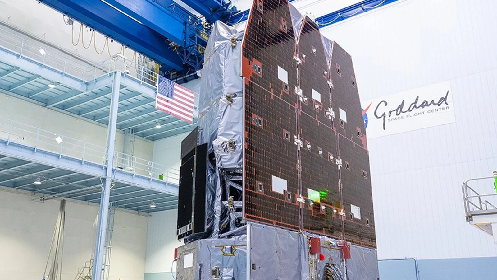NASA’s Nancy Grace Roman Space Telescope stands upright in a white clean room at Goddard Space Flight Center