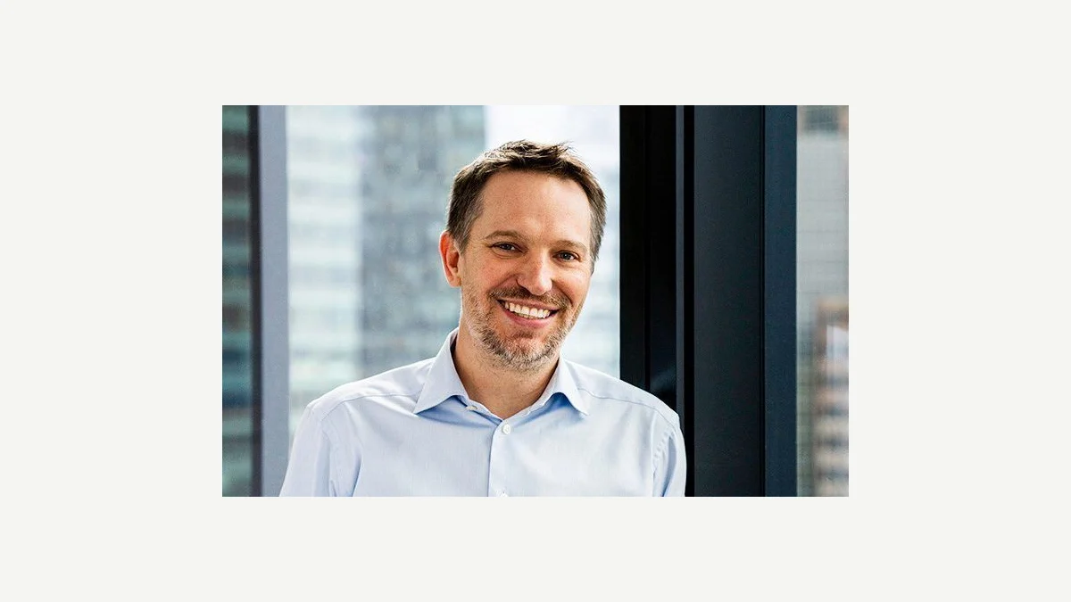 Official portrait of Ryan Roslansky, whose post describes an unhelpful exchange of AI-written workplace documents.