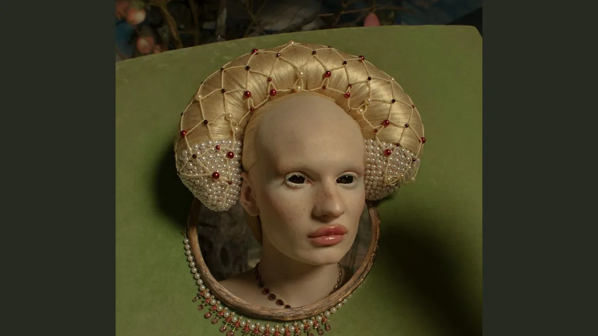 Salvia framed by a jeweled pale wig and green backdrop in Tim Walker’s Salvia as Queen portrait