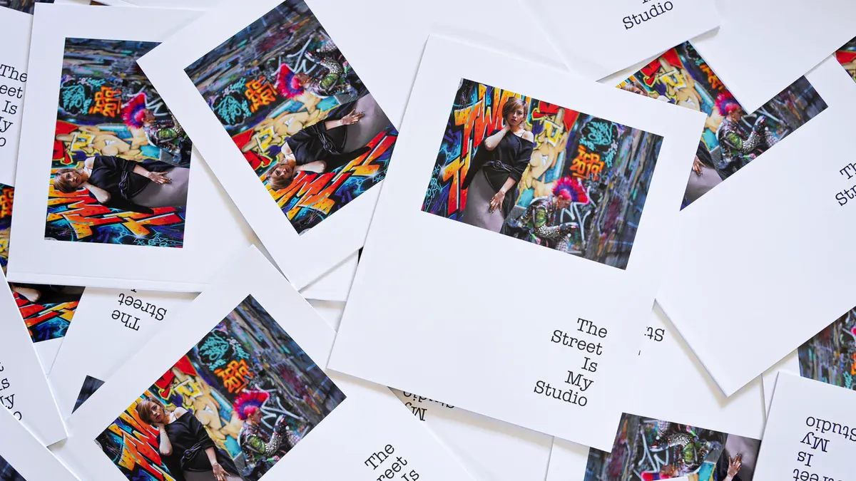 Copies of Paul Tocatlian’s The Street Is My Studio photography zine arranged on a table