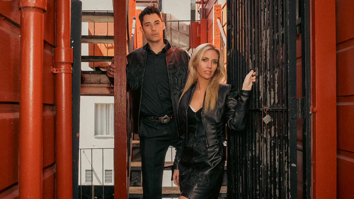 Two models wear black West Coast Leather garments in a red-painted passageway near the Union Street boutique in San Francisco.