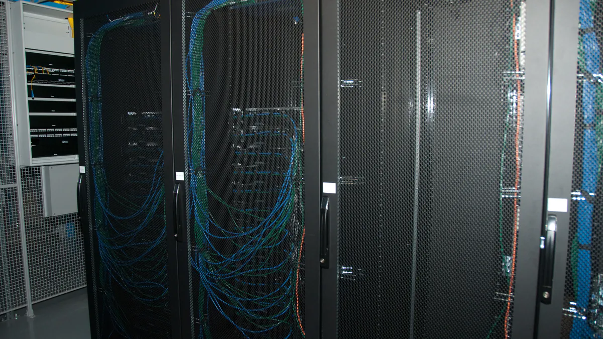 RobH’s 2011 photograph shows Wikimedia’s EQIAD server racks with cables and mesh doors
